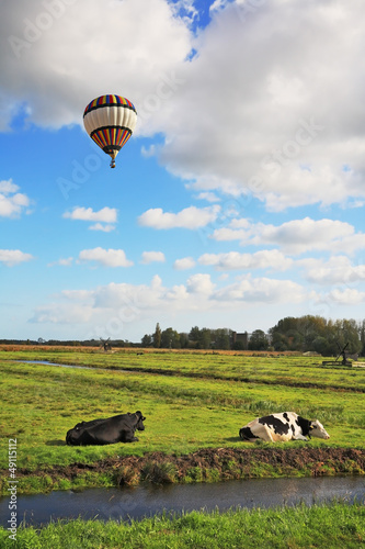 Photo: In cloudy sky flying multicolored balloon In cloudy sky flying multicolored balloon