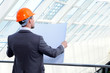 architect looking comparing housing project with building