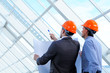 Two men in hard hats at construction site