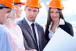 People in helmets on a construction site