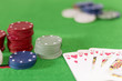 Poker game, chips and cards on green baize