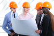 People in helmets on a construction site