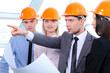 People in helmets on a construction site