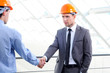 Two men in hard hats at construction site