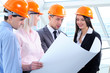 People in helmets on a construction site