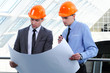 Two men in hard hats at construction site