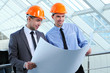 Two men in hard hats at construction site