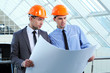 Two men in hard hats at construction site