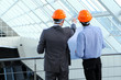Two men in hard hats at construction site