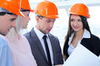 People in helmets on a construction site