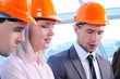 People in helmets on a construction site