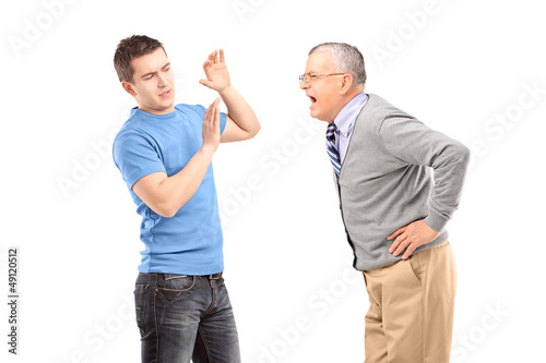 Photo: Mature man yelling at a young man Mature man yelling at a young man