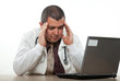 Photo: Hispanic american medical practitioner stressing on computer Hispanic american medical practitioner stressing on computer
