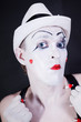 theatrical clown in white hat