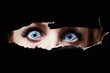 Photo: Blue eyes of a young woman peeping Blue eyes of a young woman peeping