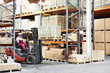 worker driver at warehouse forklift loader works