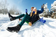 Photo: young happy couple sledding in winter young happy couple sledding in winter