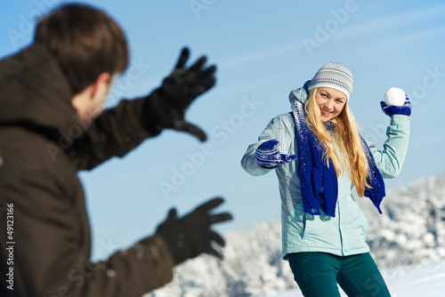 Photo: young peolple playing snowballs in winter young peolple playing snowballs in winter