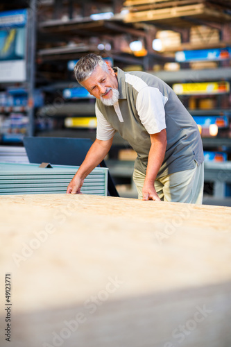 Photo: Man buying construction wood in a DIY store Man buying construction wood in a DIY store
