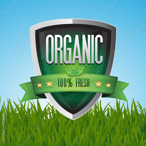 Vector: Green 100% organic shield on grass Green 100% organic shield on grass