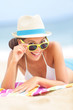 Woman on beach with sunglasses