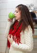 Colds woman with cup of  medicine gargling