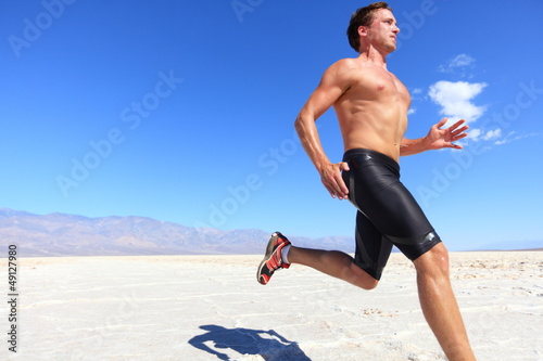 Photo: Athlete running sport - fitness runner in desert Athlete running sport - fitness runner in desert