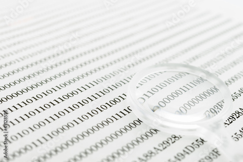 Photo: Binary code and magnifying glass Binary code and magnifying glass