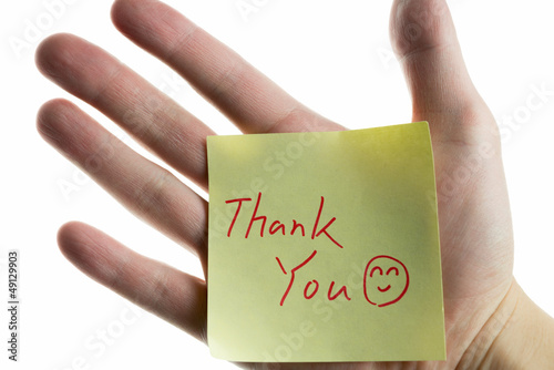 Photo: hand showing a post-it to thank you hand showing a post-it to thank you