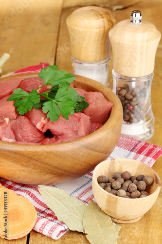 Photo: Raw beef meat with herbs and spices Raw beef meat with herbs and spices