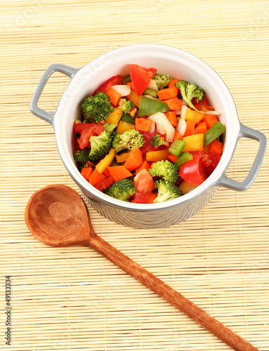 Photo: Vegetable stew in gray pot on bamboo mat background Vegetable stew in gray pot on bamboo mat background