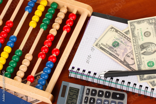 Photo: Bright wooden abacus and calculator. Conceptual photo of old Bright wooden abacus and calculator. Conceptual photo of old