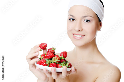 Photo: The beautiful woman with strawberry isolated The beautiful woman with strawberry isolated