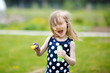 Portrait of funny little girl blowing soap bubbles