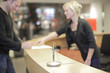 Blond woman working at help desk