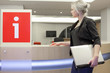 Blond woman waiting at a help desk