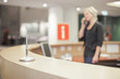 Photo: Blond woman working at help desk Blond woman working at help desk