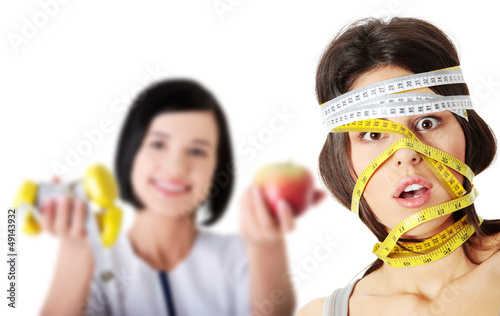 Photo: Woman with measuring tape around her head Woman with measuring tape around her head