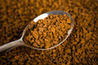 Photo: Spoon of coffee at coffe background Spoon of coffee at coffe background