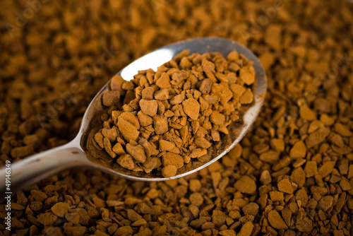 Photo: Spoon of coffee at coffe background Spoon of coffee at coffe background