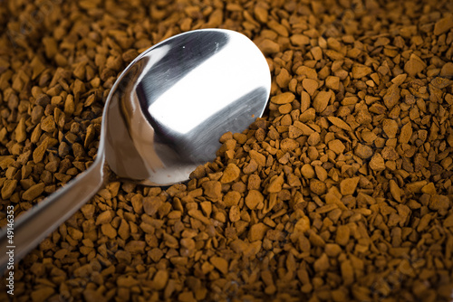 Photo: Spoon of coffee at coffe background Spoon of coffee at coffe background