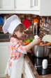little girl plays the cook and makes a dinner