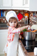 little girl plays the cook and makes a dinner