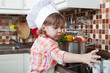 little girl plays the cook and makes a dinner
