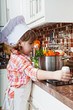 little girl plays the cook and makes a dinner