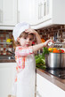 little girl plays the cook and makes a dinner