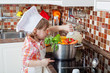 little girl plays the cook and makes a dinner