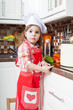 little girl plays the cook and makes a dinner
