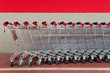 row of empty shopping carts in supermarket