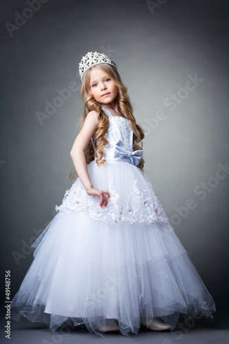 Photo: Pretty little girl in tiara and white dress Pretty little girl in tiara and white dress